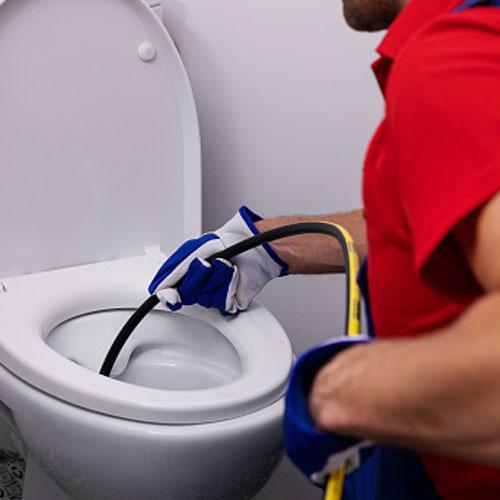 A photo of a Budget Drains Nottingham Drainage engineer unblocking a toilet with a jetter.