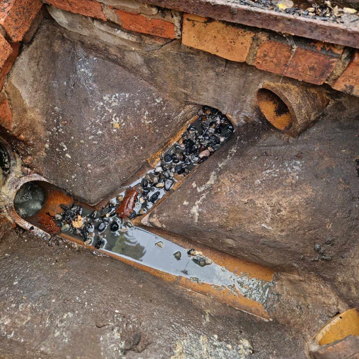 A photo taken at night, by budget drains nottingham 24/7 emergency drain unblocking team, of a heavily block drain.