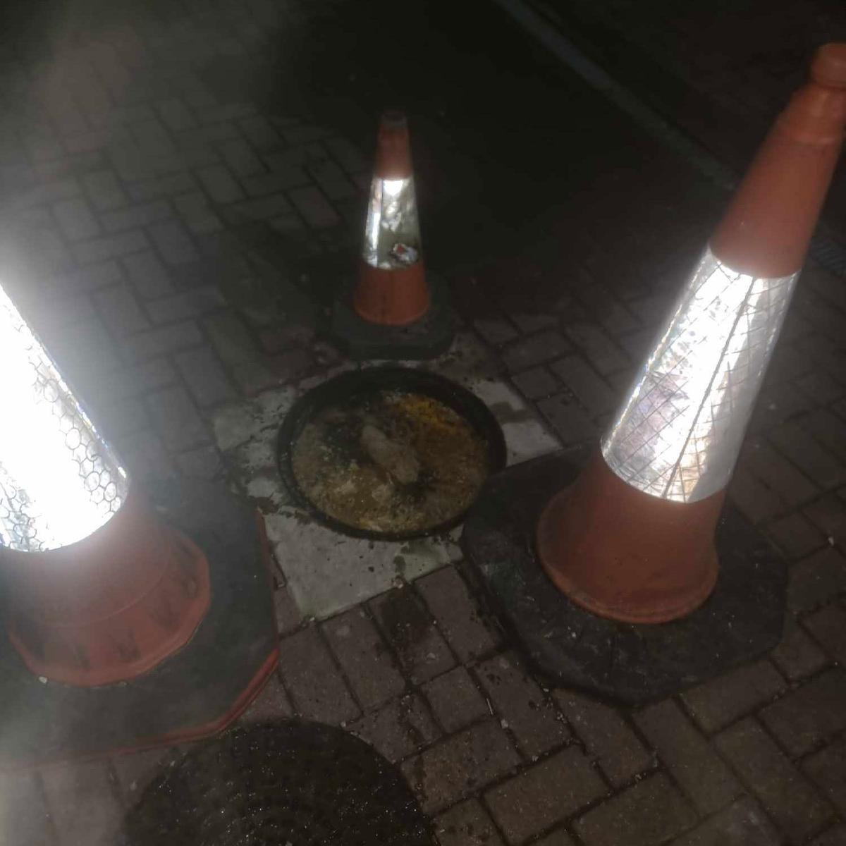 A photo at night for a drain unblocking call, with a blocked drain by grease.