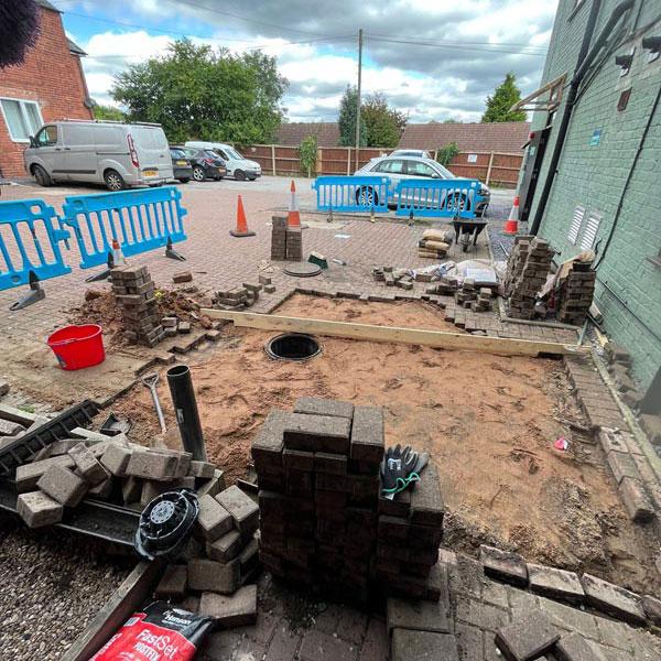 A photo of a street with a blocked drain that Budget Drains Nottingham Unblocked.